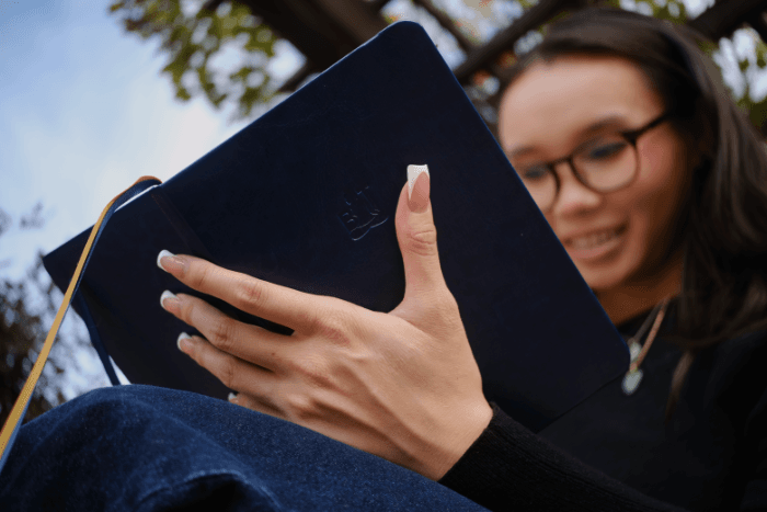 Woman journaling with Buddha Therapy mindful journal